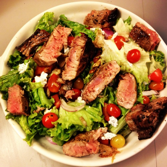 Green salad with baby tomatoes, white ash cheese and grilled tuna steaks